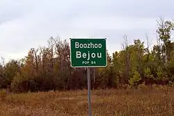 City limit sign with "Boozhoo," an Ojibwe greeting meaning "hello"