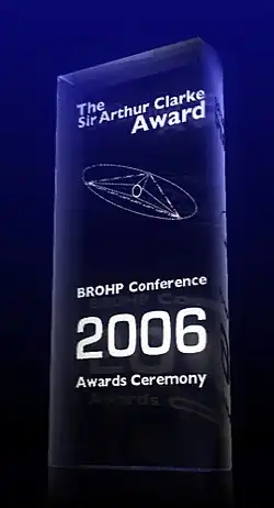 A glass 2006 Clarke Award, stating in white text "The Sir Arthur Clarke Award. BROHP Conference, 2006 Awards Ceremony".