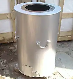 A coal-fired tandoor with a mild steel drum