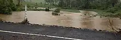 In February, when the flooding resumed, the water level of Coles Creek nearly reached the water level of Maguires Lane, Cooran.