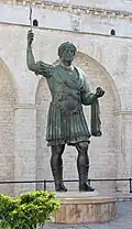 The statue from the right