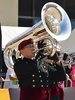 Photograph of a drum & bugle corps player playing a contrabass bugle