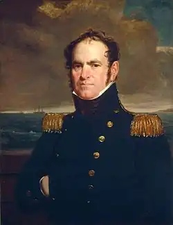 A head and chest portrait of a middle-aged man facing left wearing a high-ranked military uniform. The uniform conceals his neck, he has a determined but distant look. He has a pudgy face with prominent cheeks, and a very high balding forehead. His hair is wildly standing up, wavy and midlength.