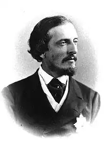 Black and white photo of Lord Dufferin, dark hair moustache and goatee, in mid-Victorian jacket and cravat, with star of a heraldic order on his lapel