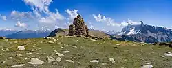 Cairn out of porphyr rocks on the alpine pasture Resciesa in Gherdëina, an Unesco World Heritage.