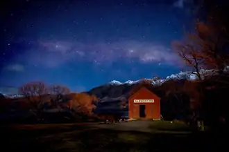 Night scene with stars visible over snow-capped mountains