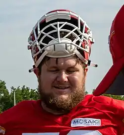 Creed Humphrey wearing a football helmet and red jersey
