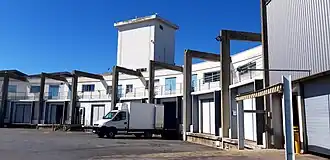 Loading a refrigerated truck and ice tower at the fish auction.
