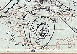 Weather map indicating barometric pressures over the southwestern Caribbean Sea using contours and wind barb symbols to indicate observations in select locations during the represented time. The hurricane is denoted at center with a capital L.