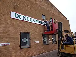 Installation of the first museum sign outside the home of the Dundee Museum of Transport