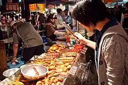 Locals browsing the selection of snacks on display at the night market, 2008