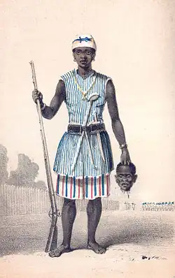 Seh-Dong-Hong-Beh, leader of the Dahomey Amazons, holding a severed head