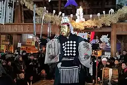 Men with golden mask holding a sword.