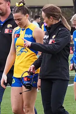 Pearce walking towards the interchange bench during a football match
