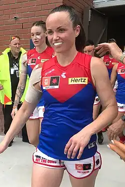 Pearce walking out of her team's changerooms followed by her teammates