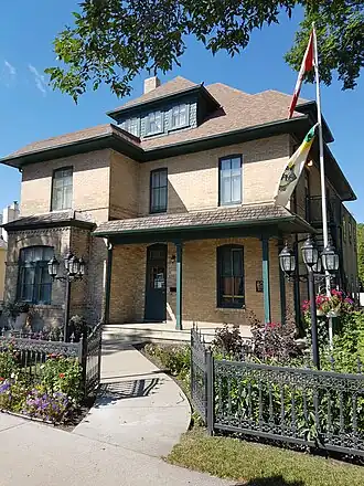 Exterior view of Daly House Museum, a two-and-a-half-storey brick-veneered residence in Brandon, Manitoba