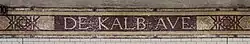 A tile mosaic at the station, with the name "De Kalb Ave" in capital letters.