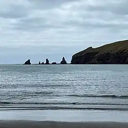 The distinctive rocks at the head of bay are the origin of the name.