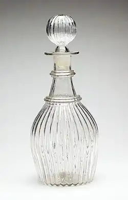 A glass decanter and stopper