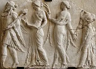 Procession of four figures, the first male