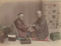 Image 30A doctor checks a patient's pulse in Meiji-era Japan. (from History of medicine)