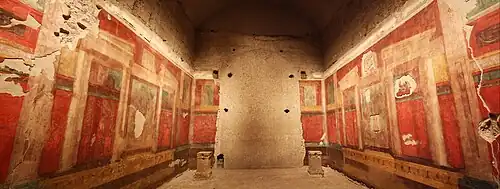 A room with frescos along the walls