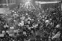 Protesters marching carrying signs