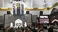 The head cleric displaying the relic inside the mosque in 2019