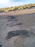 Old World War II anti-tank defences. Now buried by time and sand.