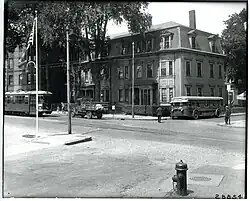 A streetcar and a bus on a city street