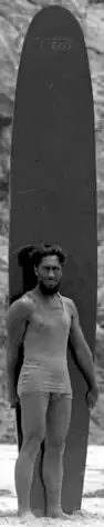 A man wearing a tank top and pants