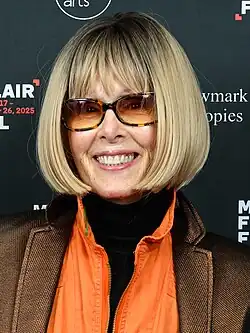 Carroll wearing sunglasses and smiling
