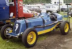 Bira's third ERA, chassis R12B Hanuman II, in the final Thai racing scheme of pale blue with yellow chassis rails and wheels. The Thai flag is placed in the subsidiary position, at the left leading edge of the car's bonnet, to represent the driver (it is also on the tail)
