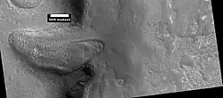 Glacier moving out of valley, as seen by HiRISE under HiWish program Location is Ismenius Lacus quadrangle.