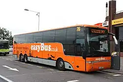Orange and grey Mercedes-Benz minibus with 'easyBus.co.uk' signwriting on front and side
