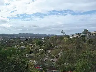 Homes along an elevated ridge with other Logan City suburbs in the background, 2014