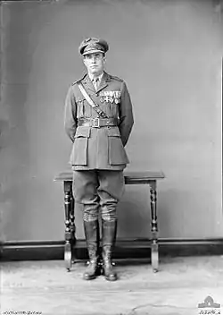 Full-length portrait of man in military uniform wearing medals