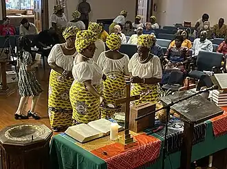 Sanctuary of Edgewater Presbyterian Church during a worship service with Cameroonian women in special African attire