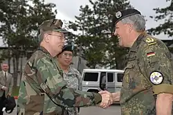 Bryant observes as Admiral Edmund Giambastiani greets German Lieutenant General Roland Kather in May 2007.