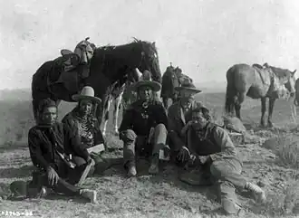 Three of Custer's scouts accompanying Edward Curtis on his investigative tour of the battlefield, c. 1907. Left to right: Goes Ahead, Hairy Moccasin, White Man Runs Him, Curtis, and Alexander B. Upshaw (Curtis's assistant and Crow interpreter)