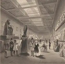 Black and white engraving of a spacious museum gallery: men and women dressed in fine Victorian-era clothing admire and sketch fragments of Greek sculpture