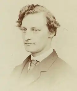 Black-and-white photo of Hughes in a coat