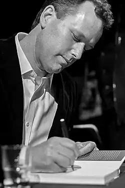 A man signing a book