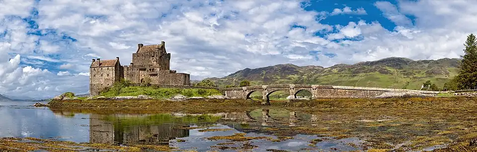 Eilean Donan Castle is a historic Scottish fortress located on a small tidal island at the meeting point of three sea lochs in the Highlands. Panorama of the castle from the south