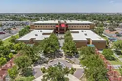 A drone shot of the main complex of the EPCC Valle Verde campus, with the central fountain visible, as well as multiple pathways lined with trees.