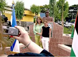 Descendants of Palestinians take a picture beside a bust of Yasir Arafat, San Salvador.