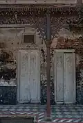 Cast iron column and arch opening with floral ornamentation (building #31, built in 1928 AD)