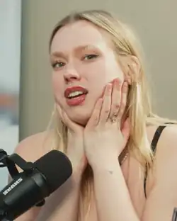 Legzdiņa in front of a microphone