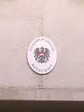 Plaque outside the embassy in German depicting the coat of arms of Austria