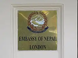 Plaque outside the embassy depicting the Emblem of Nepal